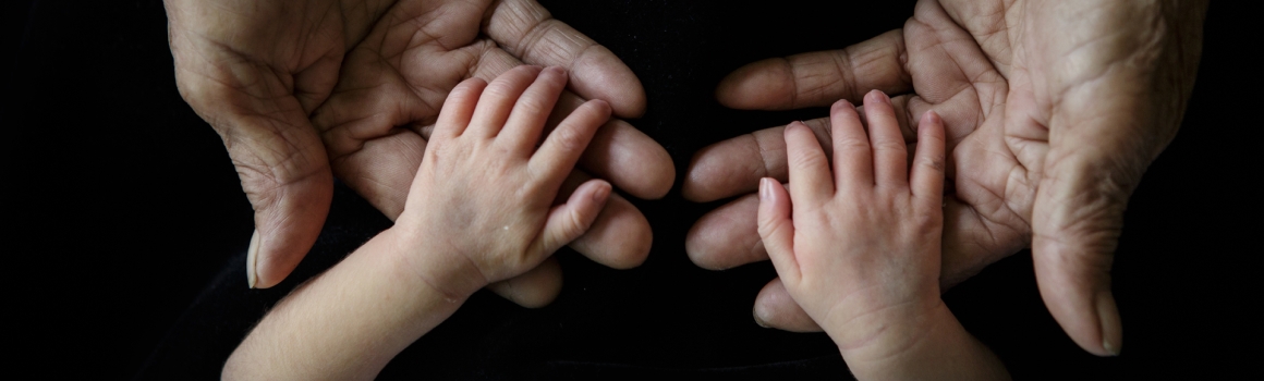 Grandmother holding grandchild's hands (soft and blurry); Is epilepsy hereditary