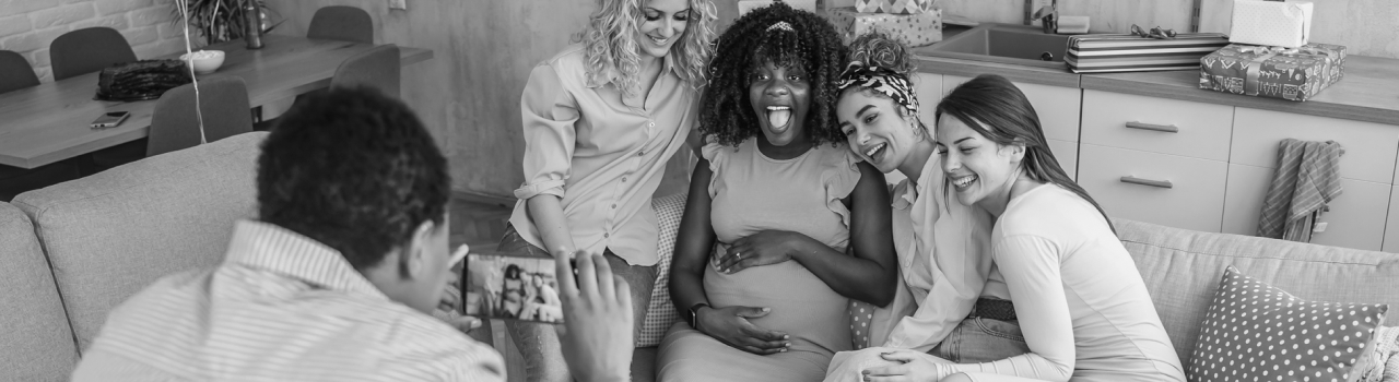 Woman taking photos with her friends at baby shower