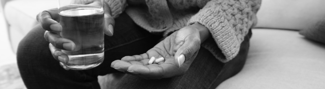 Person holds capsule and water