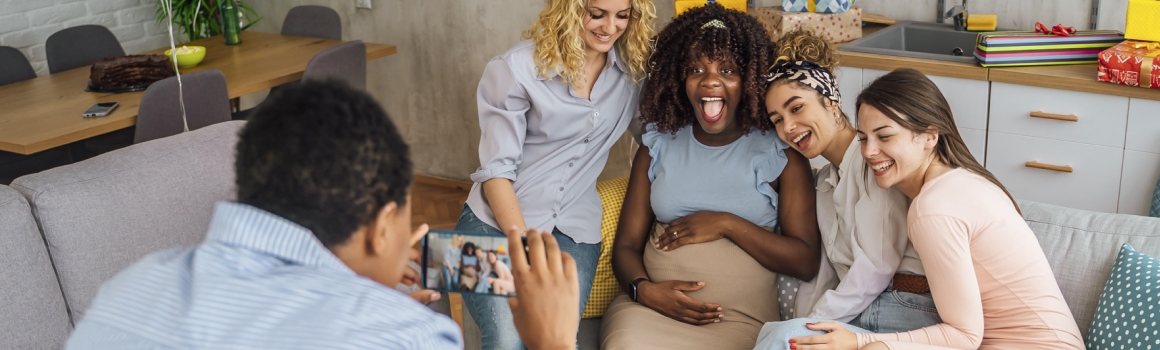 Woman taking photos with her friends at baby shower
