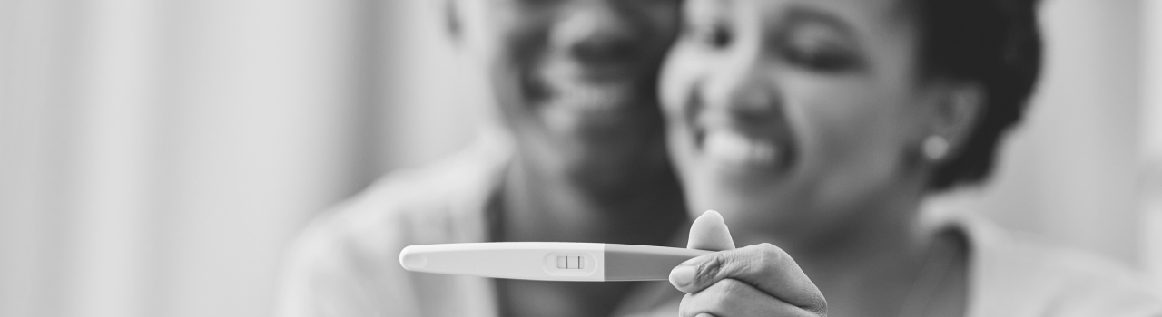 Man and woman looking at a pregnancy test