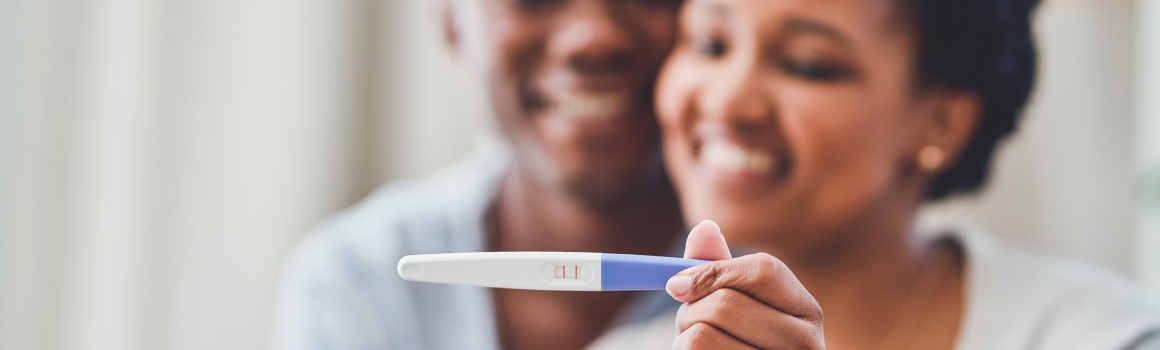 Man and woman looking at a pregnancy test